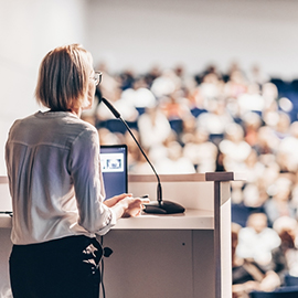 Female speaker at conference.