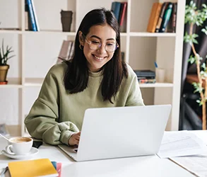 Woman smiling at laptop