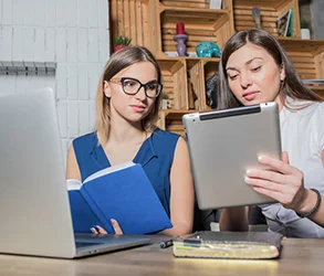 Women engaged with a laptop.